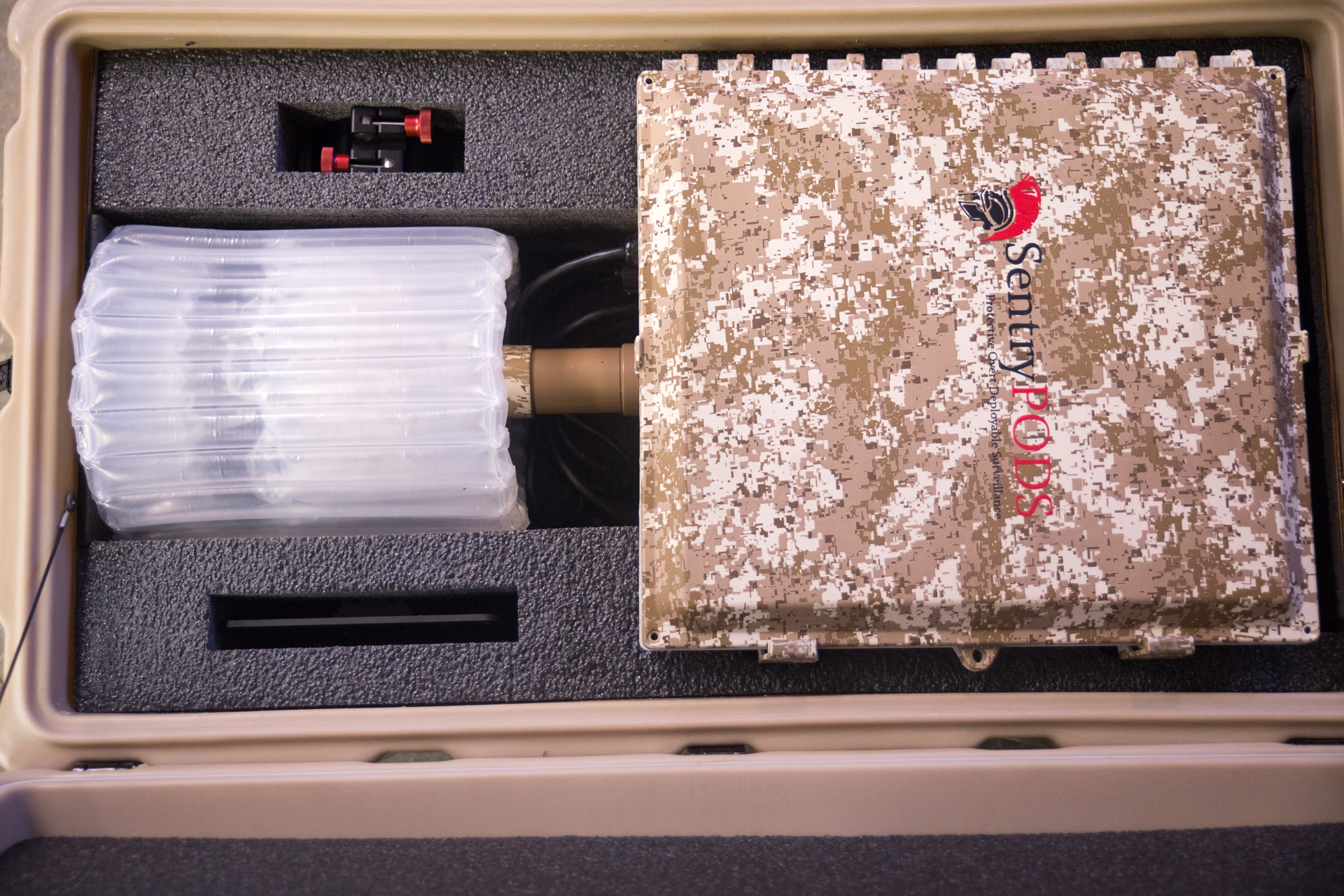 Open ruggedized SentryPODS case with organized surveillance components