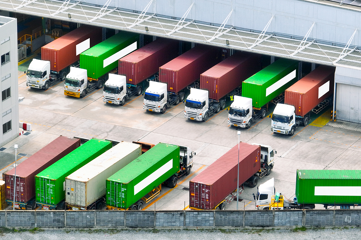 Freight trucks at warehouse loading dock. Industry logistics and distribution center. Logistics delivery and transportation. Supply chain. Shipping and cargo management. Industrial logistics hub. Freight trucks at warehouse loading dock. Industry logistics and distribution center. Logistics delivery and transportation. Supply chain. Shipping and cargo management. Industrial logistics hub.