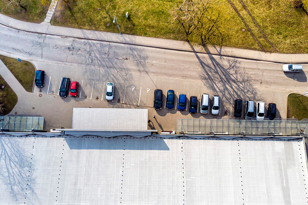 top view of many cars parked on a parking lot at the shopping c hotel security & surveillance cameras