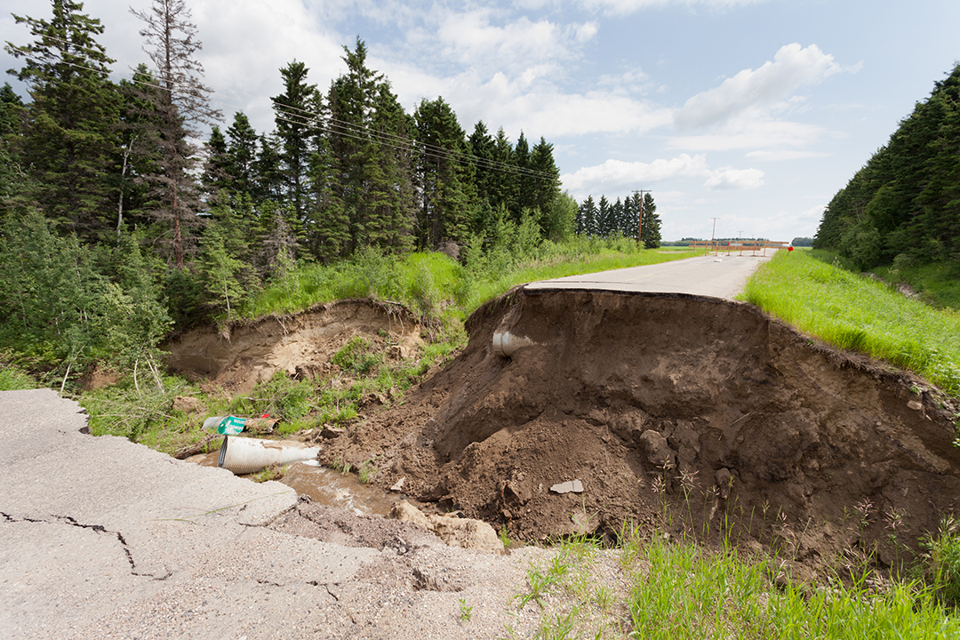 Washout: rain flood damaged badly washed out road