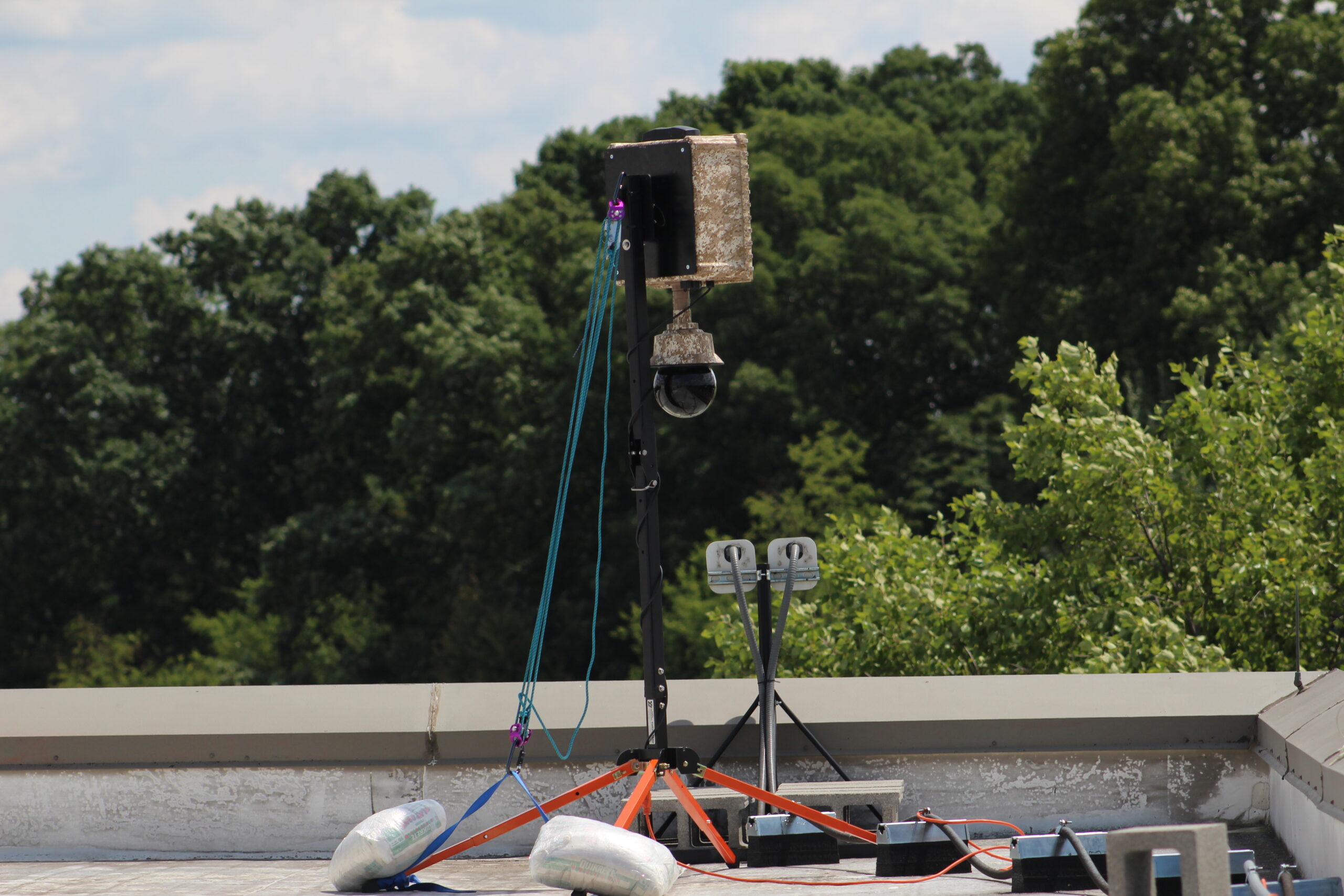 SentryPODS surveillance camera installed on an extendable rooftop mast