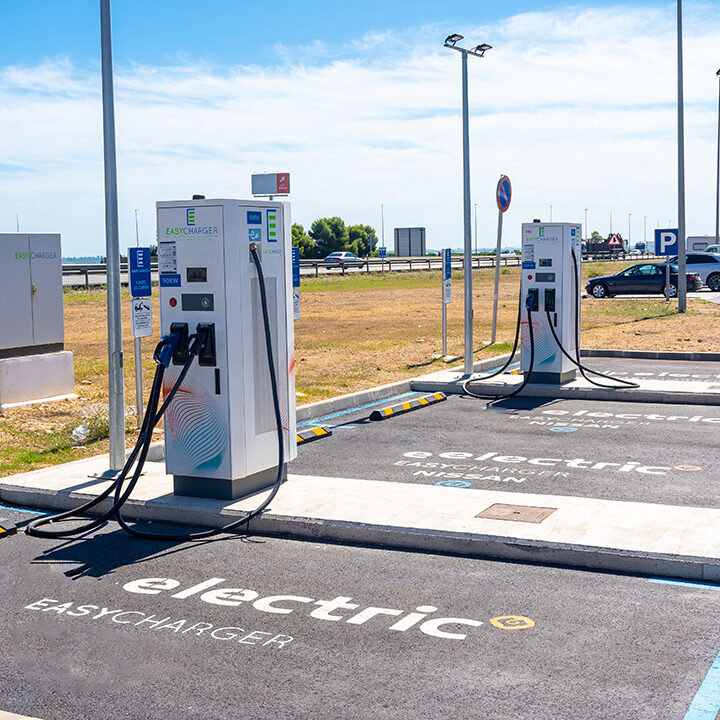 Electric car chargers at a gas station, with a parking space. ecological mobility