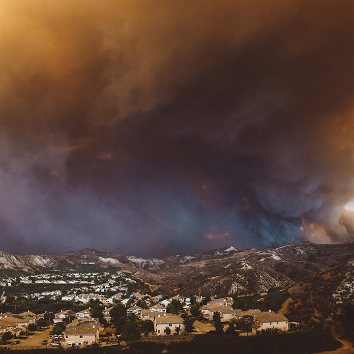 The smoke from Sand brush fire covering Santa Clarita cityscape at sunset in California